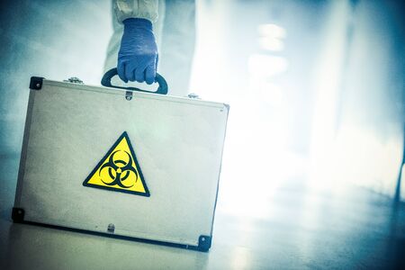 corona virus concept. male doctor taking biohazard caseの写真素材
