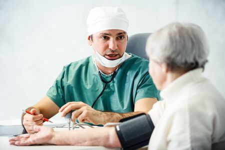 healthcare in hospital concept. male doctor consulting old ladyの写真素材