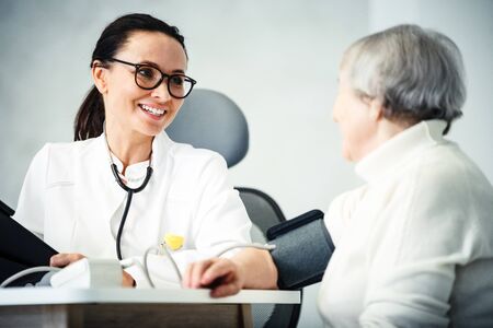 healthcare in hospital concept. female doctor consulting old ladyの写真素材