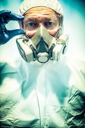 corona virus concept. male doctor putting on maskの写真素材