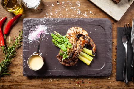 Tasting menu. Beef steak and grilled tiger prawns.の写真素材
