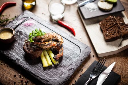 Tasting menu. Beef steak and grilled tiger prawns.の写真素材