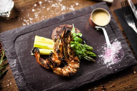 Tasting menu. Beef steak and grilled tiger prawns.の写真素材