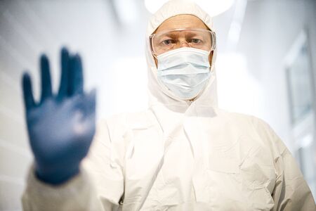 corona virus concept. male doctor showing stop signの写真素材