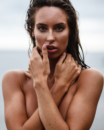 beautiful young lady in bikini posing on a beachの写真素材