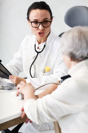 healthcare in hospital concept. female doctor consulting old ladyの写真素材