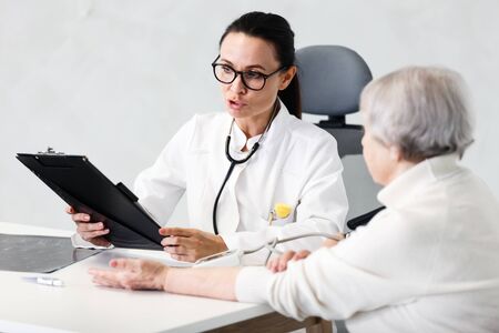 healthcare in hospital concept. female doctor consulting old ladyの写真素材