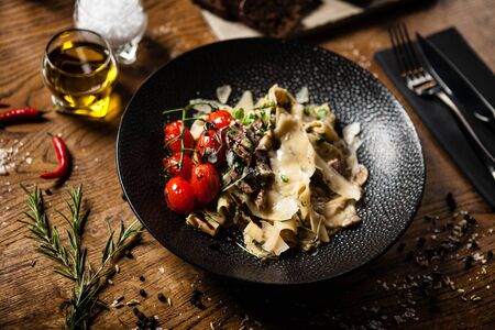 Black Angus Pasta served in a black bowl in restaurantの写真素材