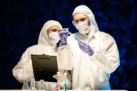 corona virus concept. two doctors reviewing test-tubeの写真素材