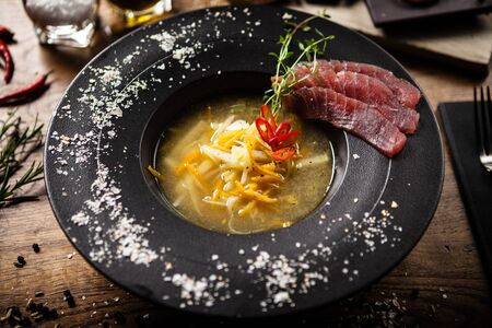 Clear Fish soup served with slices of tunaの写真素材