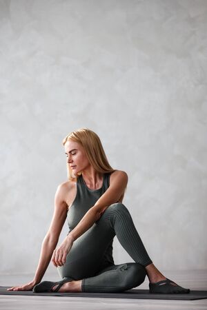 Yoga meditation at home. Beautiful young woman working outの写真素材