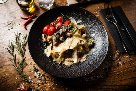 Black Angus pappardelle pasta with beef, champignon and parmegano cheeseの写真素材