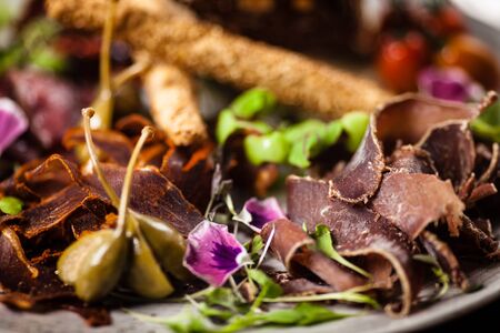 Meat platter for two: Dry-aged beef brisket, dry-aged duck fillet, beef liver pate, dry-aged lamb striploin, cranberry jam and grissiniの写真素材