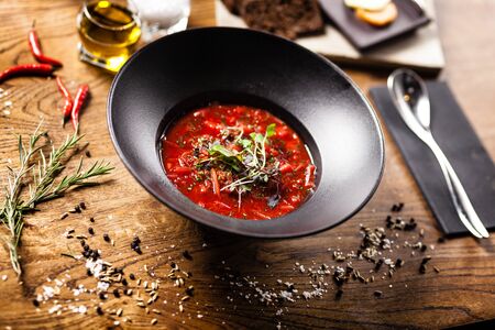 Beetroot soup Borscht with meat and sourcream in a bowl. Delicious healthy Russian traditional food closeup served for lunch on a table in modern gourmet cuisine restaurant.の写真素材