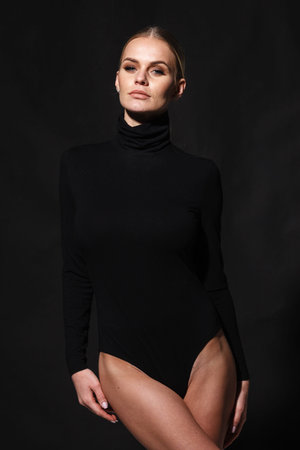 fashion and lingerie concept - beautiful blond lady portrait in sexy black turtleneck body corset on...