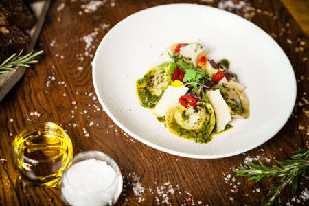 Black Angus hand-made dumplings. Cucumber-julienne with chilli-garlic butter or beef stock with sour cream. Delicious meat food closeup served on a table for lunch in modern cuisine gourmet restaurantの写真素材
