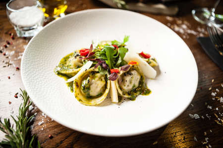 Black Angus hand-made dumplings. Cucumber-julienne with chilli-garlic butter or beef stock with sour cream. Delicious meat food closeup served on a table for lunch in modern cuisine gourmet restaurantの写真素材