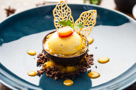 Mango, apple, cream cheese, passionfruit dessert. Delicious healthy traditional food closeup served for lunch in modern gourmet cuisine restaurant.の写真素材