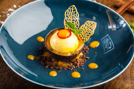 Mango, apple, cream cheese, passionfruit dessert. Delicious healthy traditional food closeup served for lunch in modern gourmet cuisine restaurantの写真素材