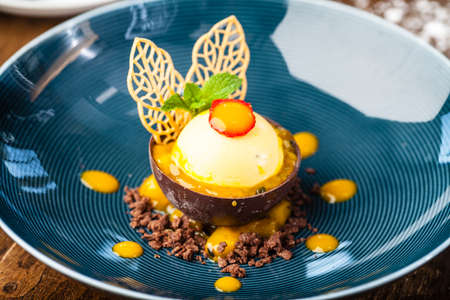 Mango, apple, cream cheese, passionfruit dessert. Delicious healthy traditional food closeup served for lunch in modern gourmet cuisine restaurant.の写真素材