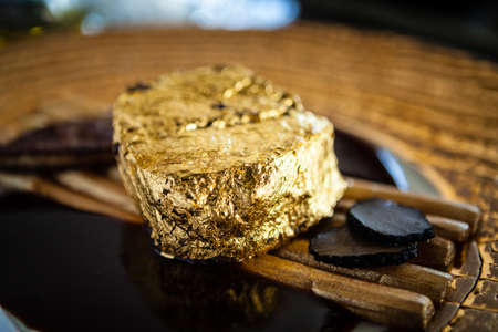 Black Angus 24 carat gold steak. Beef tenderloin, foie gras, fresh black truffle, white asparagus, port wine sauce. Delicious food closeup served for lunch in modern gourmet cuisine restaurantの写真素材