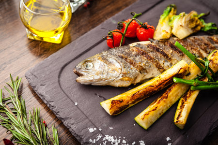 Rainbow trout grilled. Vegetables, white wine sauce. Delicious healthy traditional food closeup served for lunch in modern gourmet cuisine restaurantの写真素材