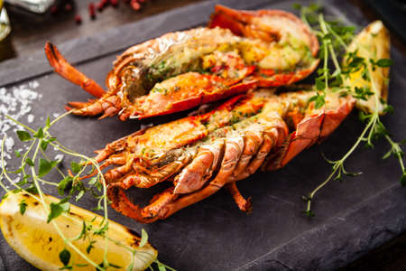 Lobster with flavored butter. Herb butter, lemon. Delicious healthy traditional food closeup served for lunch in modern gourmet cuisine restaurantの写真素材