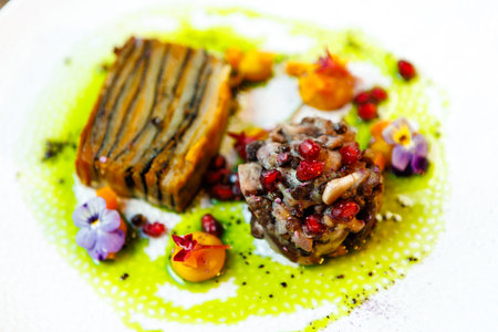 Shiitake and potatoes. Vegan. Shiitake mushroom, potato gratin, Beluga lentils, yellow beet cream. Delicious healthy traditional food closeup served for lunch in modern gourmet cuisine restaurantの写真素材