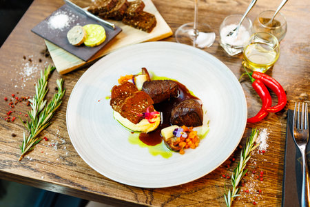 Deer tenderloin. Truffle-potato puree, porcini mushrooms, baked leek and carrot, juniper bread, port wine sauce. Delicious healthy traditional food served for lunch in modern gourmet restaurantの写真素材