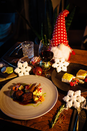 Deer tenderloin and dessert. Christmas table served for eve celebration event. Delicious healthy traditional food served for lunch in modern gourmet restaurantの写真素材