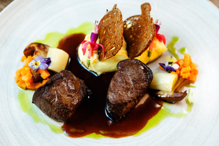Deer tenderloin. Truffle-potato puree, porcini mushrooms, baked leek and carrot, juniper bread, port...
