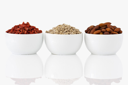 Almonds, sunflower seeds and goji berries on white backgroundの写真素材