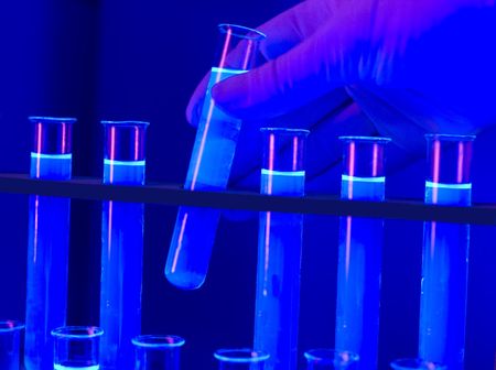 hand with test tubes blue lightの写真素材