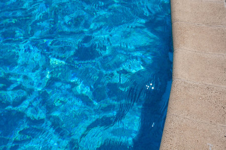 border of a swimming pool with blue water