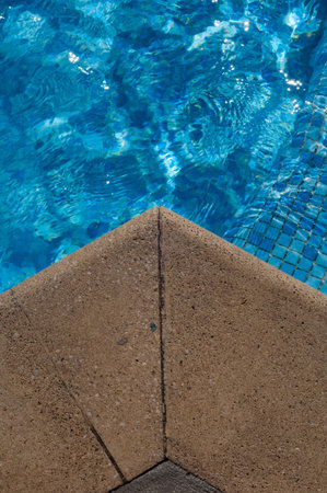 border of a swimming pool with blue water