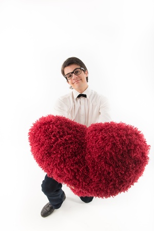 smiling young man holds a large hairy red heartの写真素材