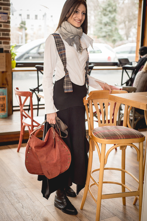 Young woman in modern clothes in trendy restaurant , caffeeの写真素材