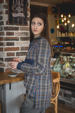 Young woman in modern clothes in trendy restaurant , caffeeの写真素材