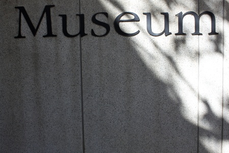 Word museum fixed on the wall and sun light on one side of the letterの写真素材