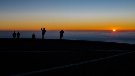 People watching the sunset above the clouds, Cima Grappa in Italyの写真素材