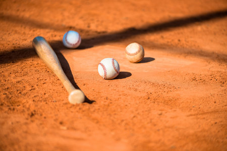 Baseballs and Bat on Home Plate