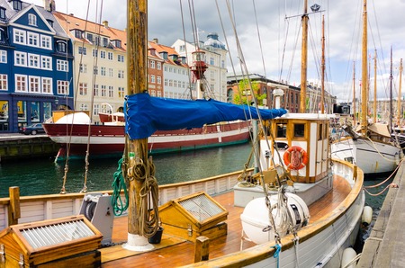 Popular tourist attraction, Nyhavn -New Harbor- with many boats, restaurants and touristsのeditorial素材