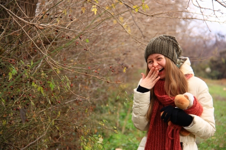 girl playing with doll in forest while smiling の写真素材