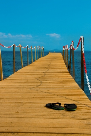 slippers on wooden peer consept of going vacationの写真素材