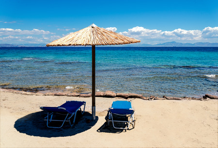 beach landscape with umbrella straw on the blue seaの写真素材