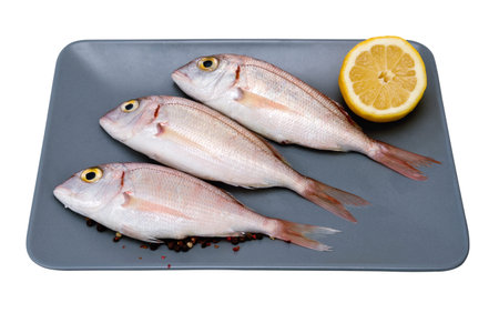 sea snapper horizontal on the plate with lemon