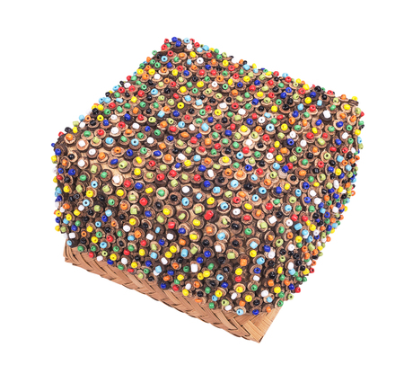 wickerwork color box of beads with white backgroundの写真素材