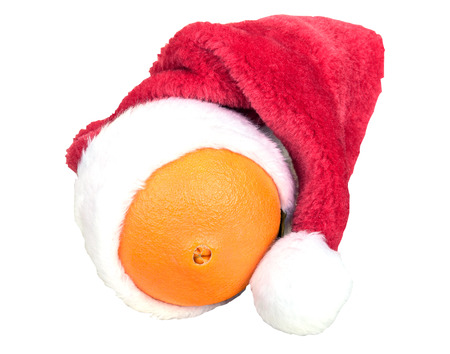 red christmas cap on orange on white backgroundの写真素材
