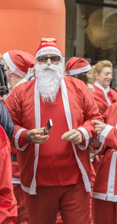 Athens, Greece - December 7, 2014: Marathon "Santa Run" - Santa Claus men with mobile phoneのeditorial素材
