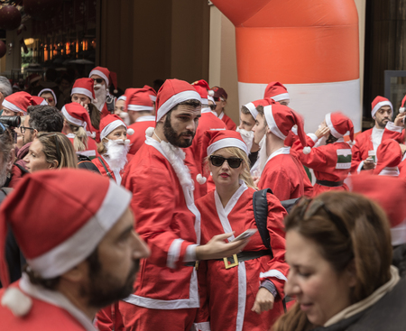 Athens, Greece - December 7, 2014: Marathon "Santa Run" - man and woman in the foreground dressed as Santa Clausのeditorial素材